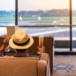man-traveler-with-hat-holding-beer-glass-and-looking-to-airplane-asian-passenger-sitting-and-relax-in-modern-lounge-at-international-airport-terminal-travel-concept-stockpack-adobe-stock