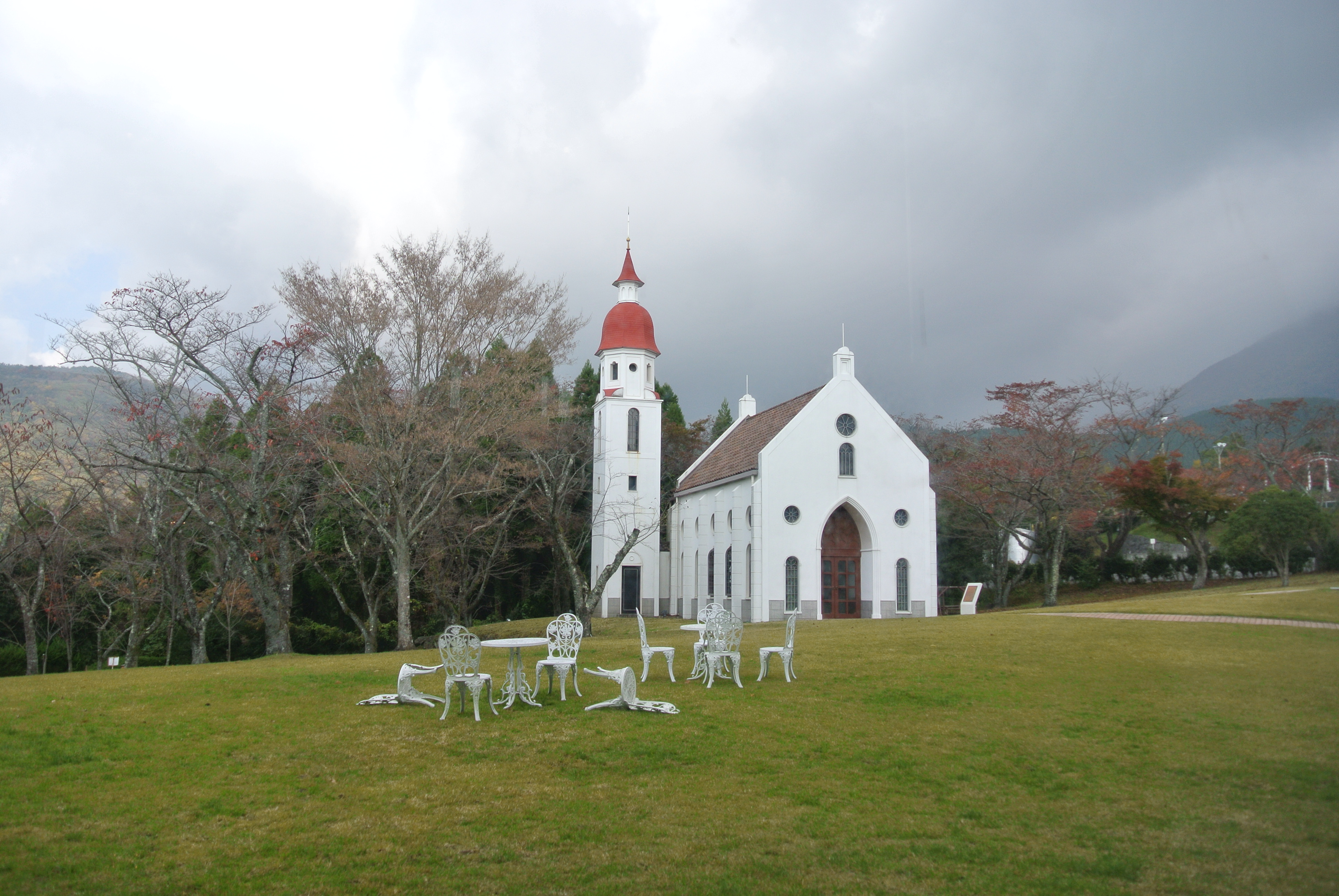 城島高原飯店旁的白色教堂與遼闊草坪，背景是高原山景